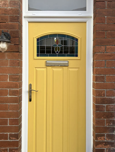 1930s style traditional arch composite front door in yellow with Edwardian style glass