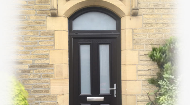 Black composite front door with part arched top light